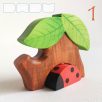 Tree trunk huts with leaf roofs and inhabitants – wooden toy