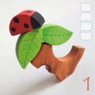 Tree trunk huts with leaf roofs and inhabitants – wooden toy